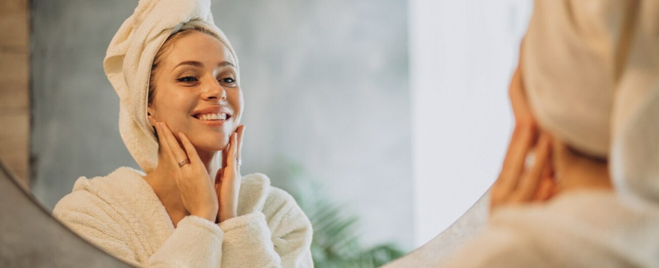 woman-home-applying-cream-mask_1303-24618