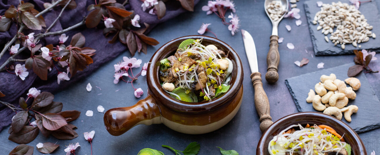 Closeup shot of a vegan meal with mushrooms, onions, carrots and leek