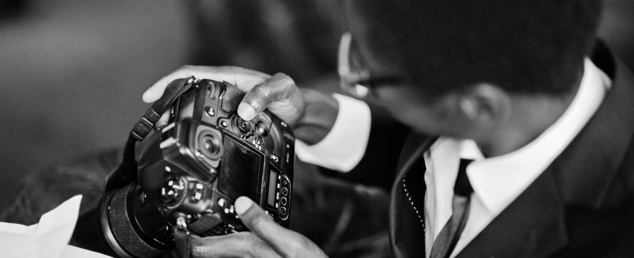 African american photographer paparazzi man wear on black suit a