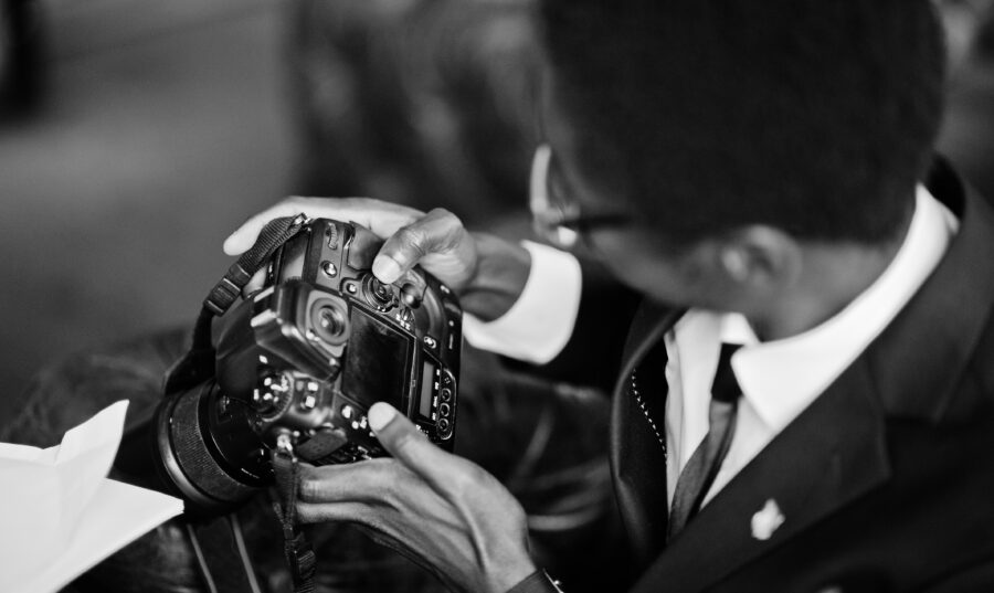 African american photographer paparazzi man wear on black suit a