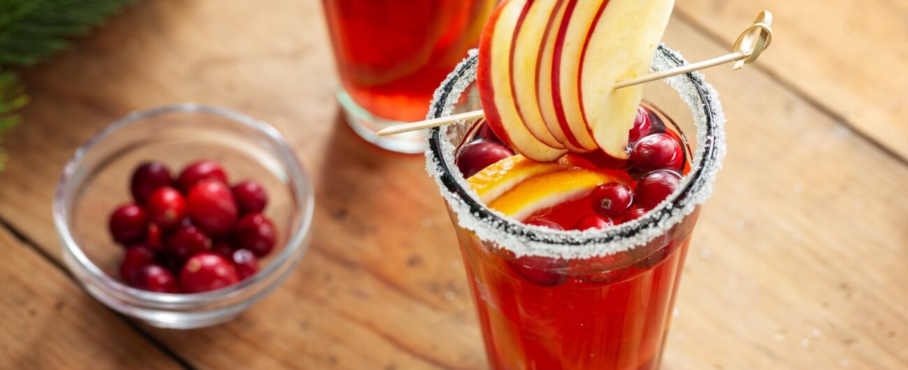 tasty-fresh-christmas-cocktail-with-cranberries-served-glasses-closeup_1220-6557