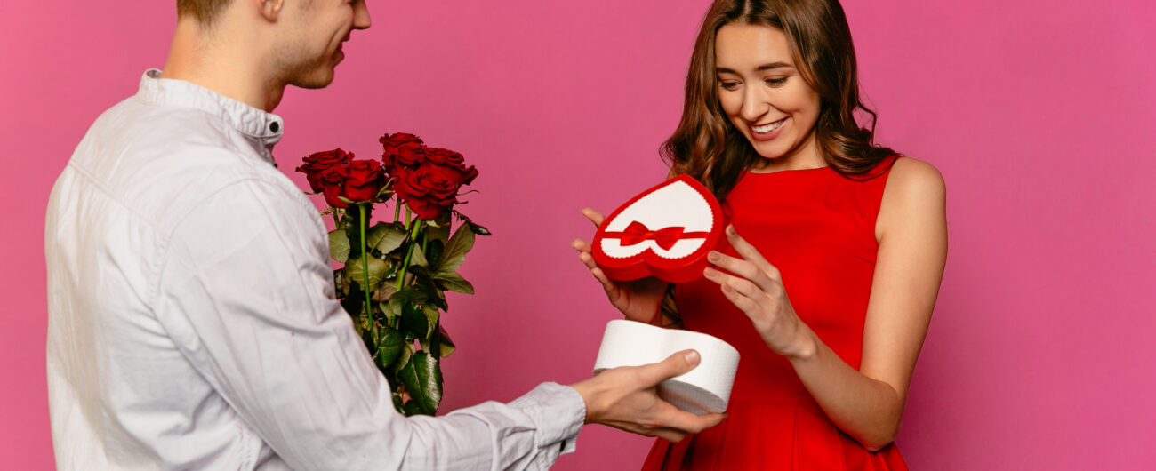 Young man with red roses making a present for his girlfriend