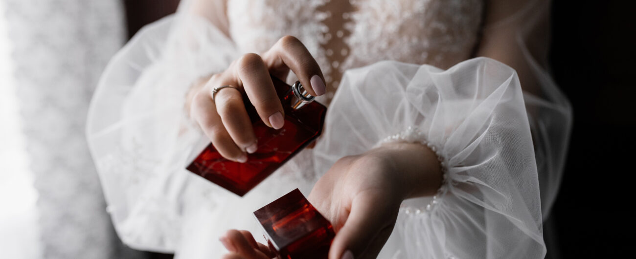 Fiancee in white fashionable dress with beautiful sleeves and pe
