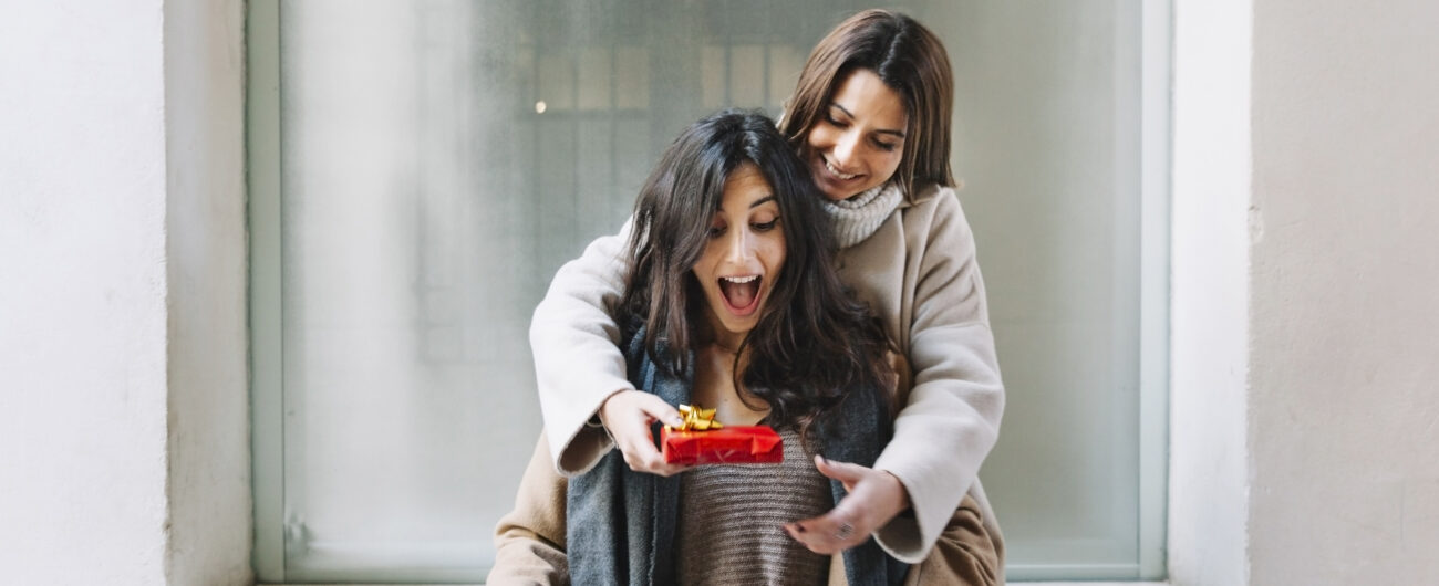 excited-woman-getting-present-from-girlfriend
